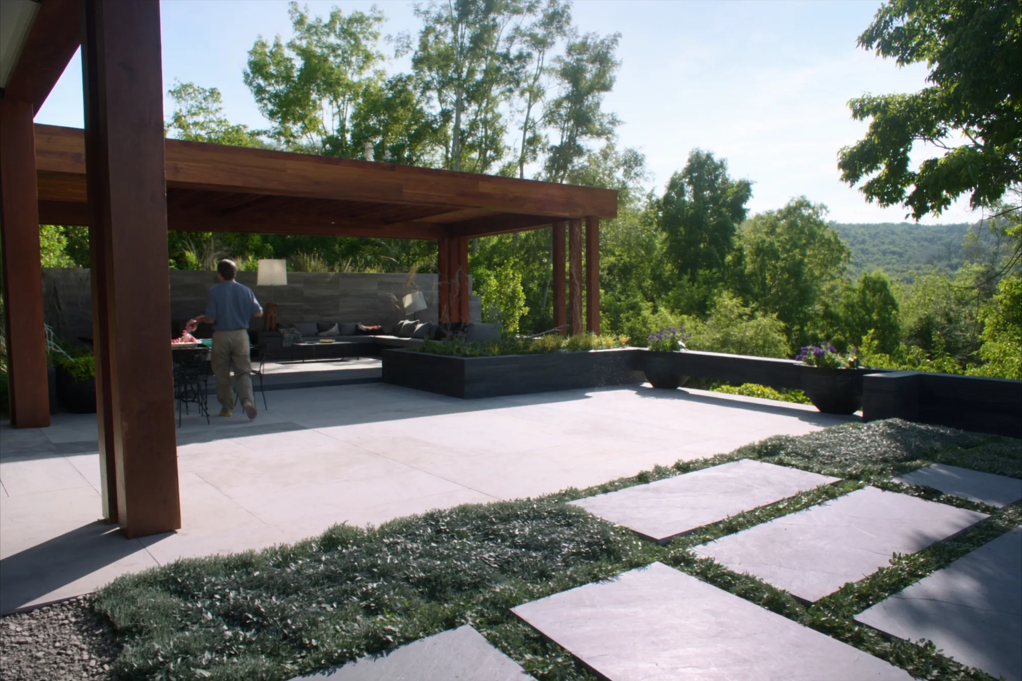 A sunlit flagstone patio and pergola on a bright afternoon